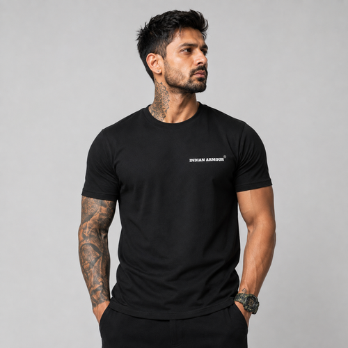 A man wearing a black short-sleeve t-shirt with a small white 'INDIAN ARMOUR' logo on the left chest